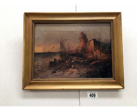 A gilt framed lithograph on canvas of a village scene