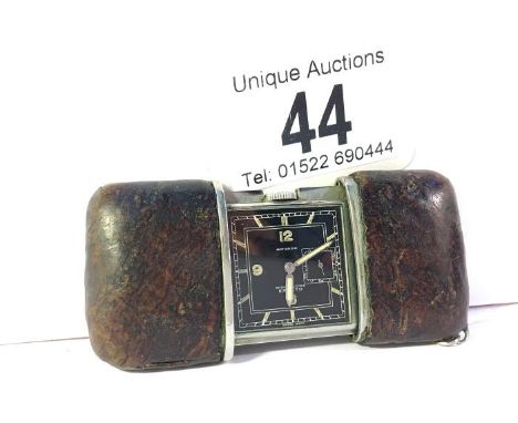 A vintage travel watch marked Movado, Chronometer, Ermeto.