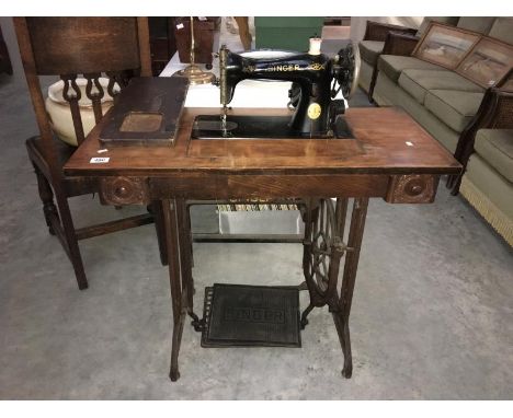 A Singer treadle sewing machine in table (complete)