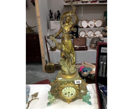 A French mantel clock surmounted figure