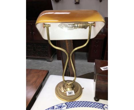 A brass adjustable reading lamp