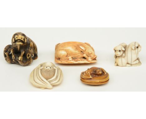 Four late Edo period Japanese ivory katabori-netsuke, in the form of a boar fighting with a fox, a boar sleeping in the shrub