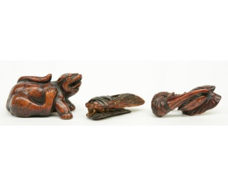Two Japanese wooden katabori netsuke, one depicting a mythical monster and one depicting a (snail) on a leaf; added a similar