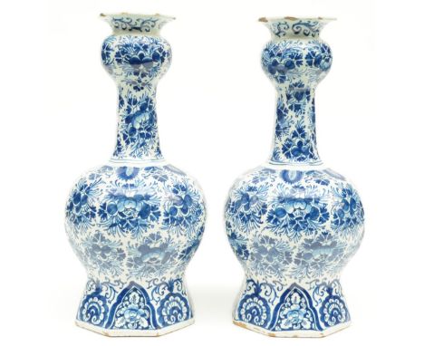 Two blue and white decorated Dutch Delftware octogonal bottle vases, marked 'De Lampetkan', 18thC, H 36 cm (chips and flaking