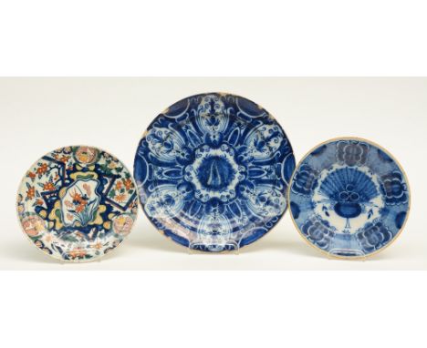 Three Dutch Delftware plates: two with blue and white decoration and one marked 'De Clauw'; one a polychrome decorated so cal