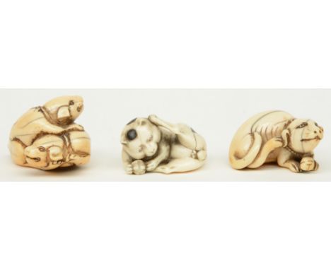 Three late Edo period Japanese ivory katabori-netsuke, in the form of playing cat and playing dogs, W 3,2 - 4cm, Total weight