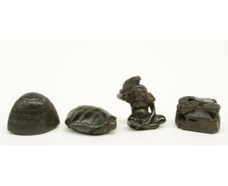 Four Japanese ebony netsuke depicting: one a man with a toad, signed; one a cottage in a landscape; one a turtle and one an i