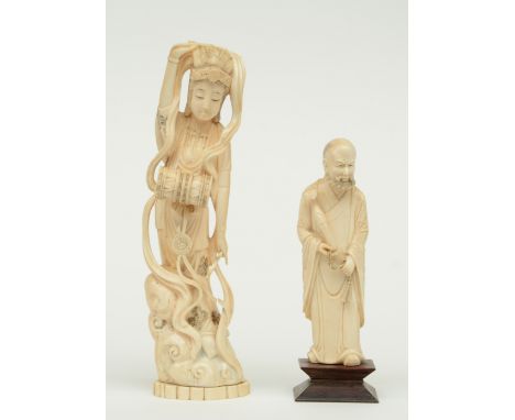 A Chinese ivory sage bearing a ruyi scepter, discrete scrimshaw decoration, late Qing dynasty; added a Chinese ivory drum pla