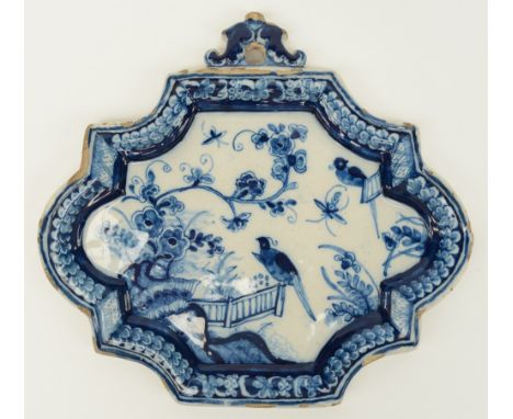 An 18thC blue and white decorated Dutch Delftware plaque depicting birds in an Oriental garden, marked, H 23 - W 25 cm