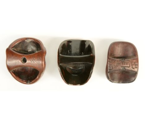 Three Japanese wooden mask netsuke, both signed; one in lacquer; all three late Edo-period, H 4 - 3,6cm.