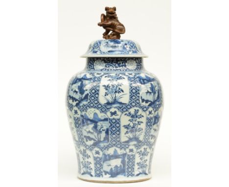 A large Chinese blue and white vase with cover, decorated with flowers and landscapes, Kangxi, H 66 cm (some restoration on t