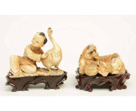 Two Chinese mammut ivory sculptures, polychrome and gilt decorated, one depicting a child and goose, one depicting Fu lions p