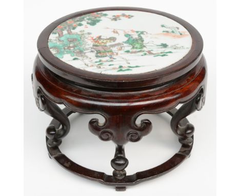 A Chinese wooden stool with a famille verte plaque decorated with a genre scene, Kangxi, H 24,5 - Diameter 32 cm (one leg wit