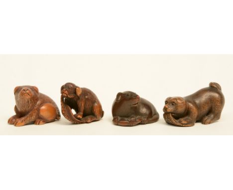 Three Japanese hardwood and horn okimono depicting a rat and two dogs; added a Japanese hardwood katabori netsuke depicting a