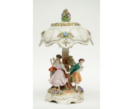 A German polychrome decorated porcelain table lamp,  the central part set with a dancing party, H 56,5 cm (minor damage)