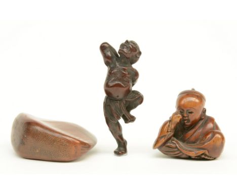Three Japanese wooden katabori netsuke, one depicting a dancer; one a crying kabuki actor (signed), and one a nut, late Edo-p