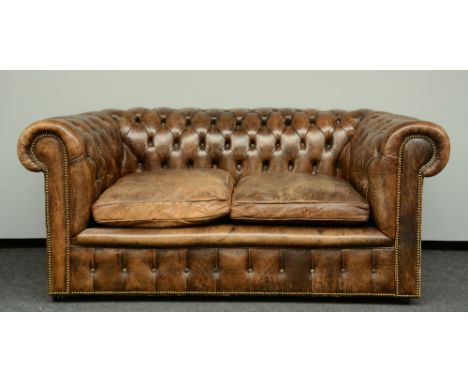 A Chesterfield sofa with brown leather upholstering,  H 77 - W 177 - D 96 cm