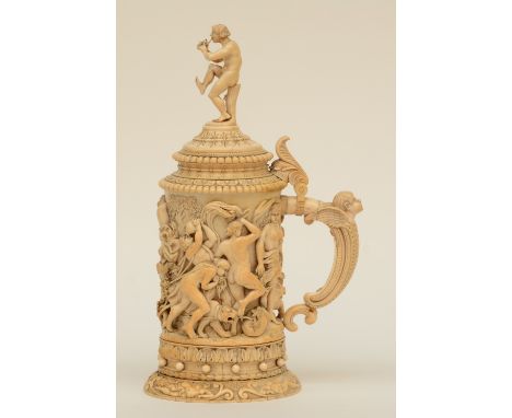 A rare German ivory Humpen, alto relievo sculpted with Bacchus on a chariot preceded by a drunken procession of welcome, ca. 