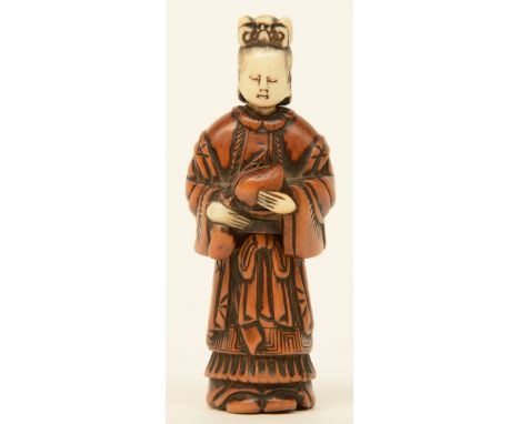 A Japanese early Meiji period  erotic boxwood and bone netsuke depicting a lady, out of two parts, H 8,6cm, Total weight 30g