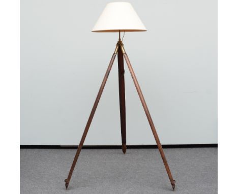 A decorative floor lamp with a 19thC tripod feet, H 183 cm