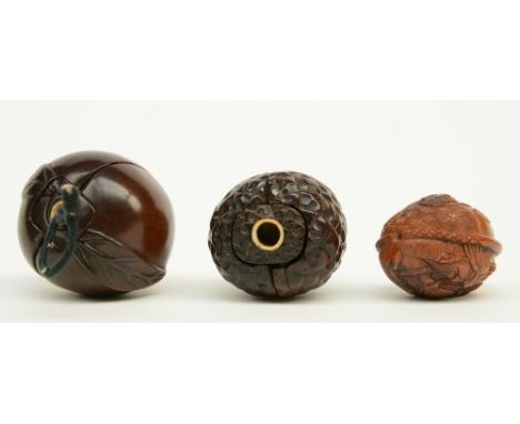 Two Japanese wooden karakuri netsuke, one in the form of a peach with inside two Go-playing man; the other one in the form of