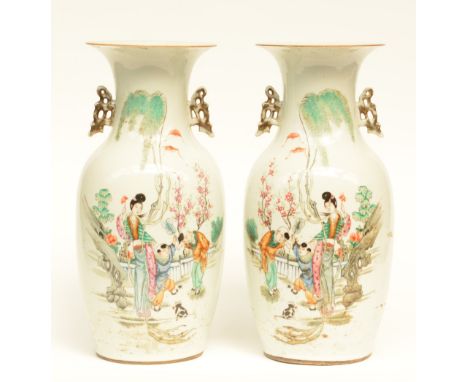 A pair of Chinese polychrome vases, decorated with children playing in a garden, H 43 cm
