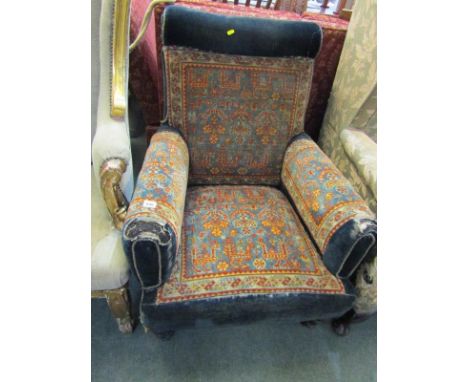 EDWARDIAN CARPET UPHOLSTERED ARMCHAIR, tapering turned legs with original castors 