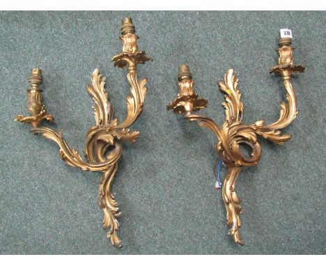 ORNATE BRASS WALL LIGHT FITTINGS, a pair of foliate decorated twin wall light fittings, 17" 