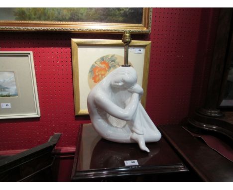 A white ceramic table lamp base in the form of a seated woman