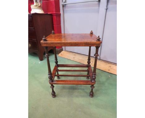 An early Victorian burr walnut two tier lamp table, the turned finials and legs joined by a slatted shelf, 70cm x 47cm x 35cm