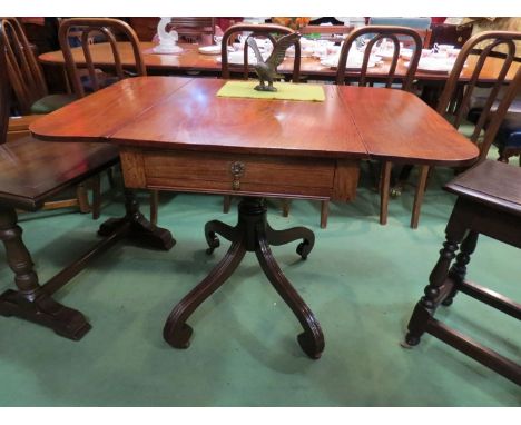 A circa 1850 mahogany drop-flap table on turned column and reeded scroll foot legs with single drawer and ceramic castors