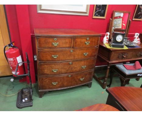 A Georgian walnut crossbanded bow-front chest of two short over three long graduating drawers, brass handles, bracket feet, s