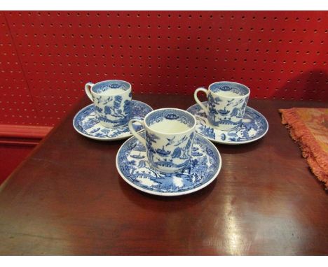 A set of six Wedgwood "Willow" pattern coffee cans and saucers
