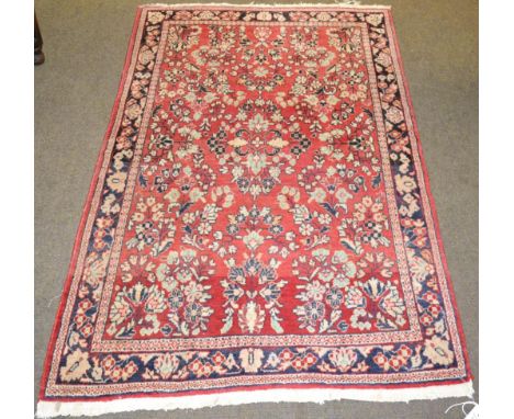 A Saroukh rug, West Iran, the strawberry field of flowering plants enclosed by narrow borders,m 152 by 98cm