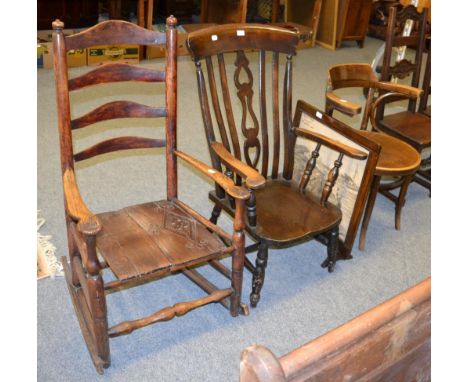 A ladder back rocking chair, a 20th century Windsor armchair, another armchair and a fire screen (4)