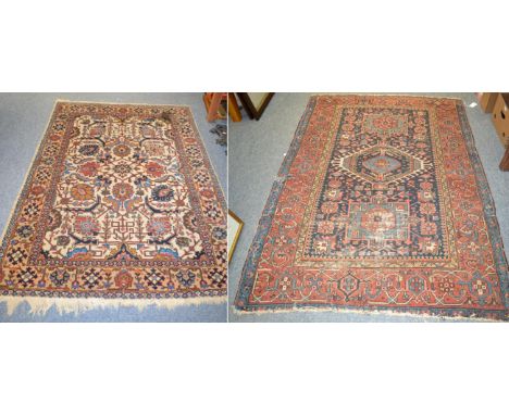 Heriz rug, Iranian Azerbaijan, the indigo field with three medallions enclosed by madder borders, 191cm by 139cm and another 