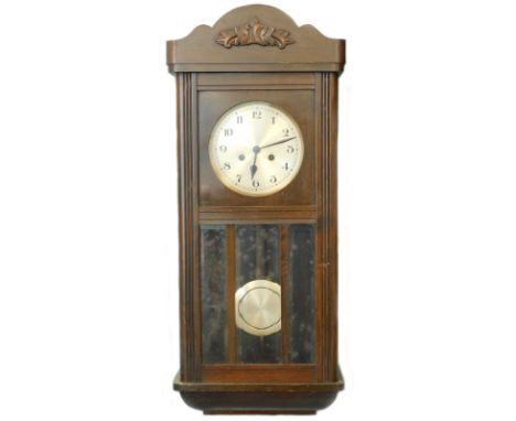 An early 20thC oak cased wall clock, with silvered dial, 79cm high.