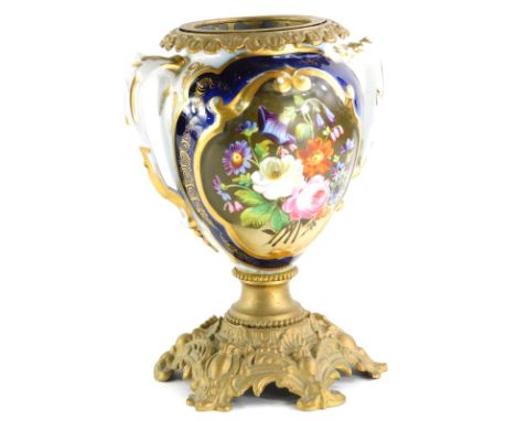 A 19thC Paris porcelain oil lamp base, with gilt metal mount, painted with flowers, within a gilt cartouche with cobalt blue 