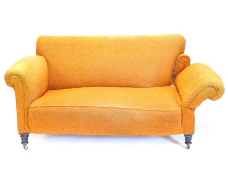 A late 19th/early 20thC two seat drop arm sofa, upholstered in yellow fabric with turned legs and castors, 151cm wide.