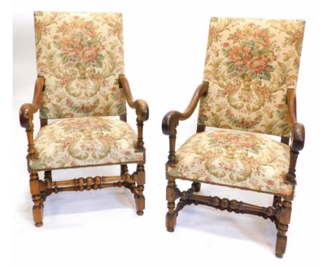 A pair of 19thC French open armchairs, each with a padded back and seat, upholstered in tapestry type fabric, on turned suppo