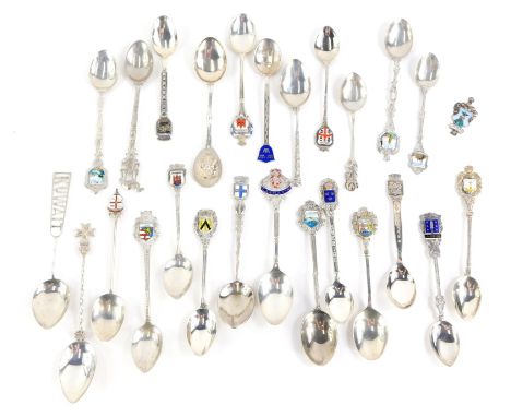 A quantity of continental white metal souvenir spoons, some with enamel decoration.