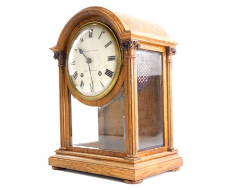 A late 19th/ early 20thC oak mantel clock, the dial stamped H.L. Brown and Sons Ltd London and Sheffield, the arched case wit