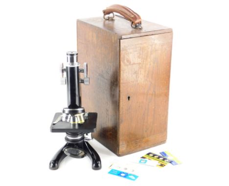 A Beck &amp; Co microscope, in a fitted oak case, with leather handle.