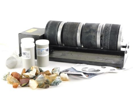 An electric stone or lapidry tumbler, with some grits, four drums, instruction manual and mineral samples.