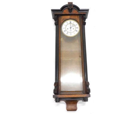 A late 19thC Vienna walnut and ebonised wall clock, with enamel dial, figured case, 102cm long.