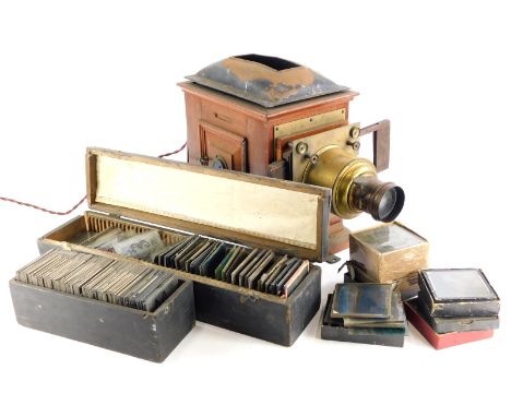 A late Victorian mahogany and brass magic lantern, with a quantity of magic lantern slides, various types to include topograp