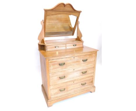 A Victorian pale walnut dressing table, the raised back with an arched bevel mirror plate above two trinket drawers, an arran