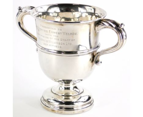 A George V silver two handled trophy cup, engraved 'presented to Mr Leonard Ernest Weldon, with the best wishes of the staff 