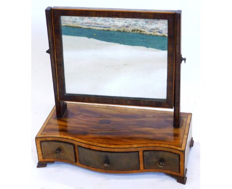 A 19thC mahogany and boxwood strung dressing table mirror, the rectangular plate above a serpentine fronted and cross banded 