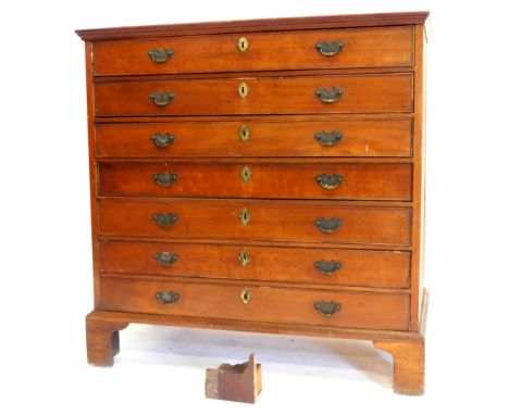 An early 19thC mahogany chest of drawers, the top with a crossbanded border and a moulded frieze, above an arrangement of sev